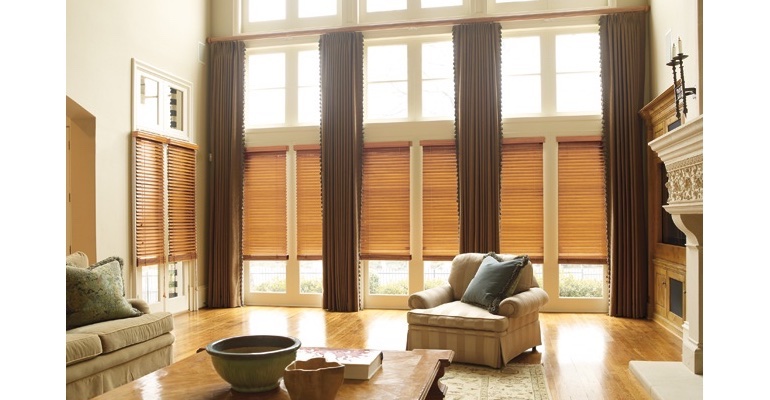 Houston great room with natural wood blinds and floor to ceiling drapes.